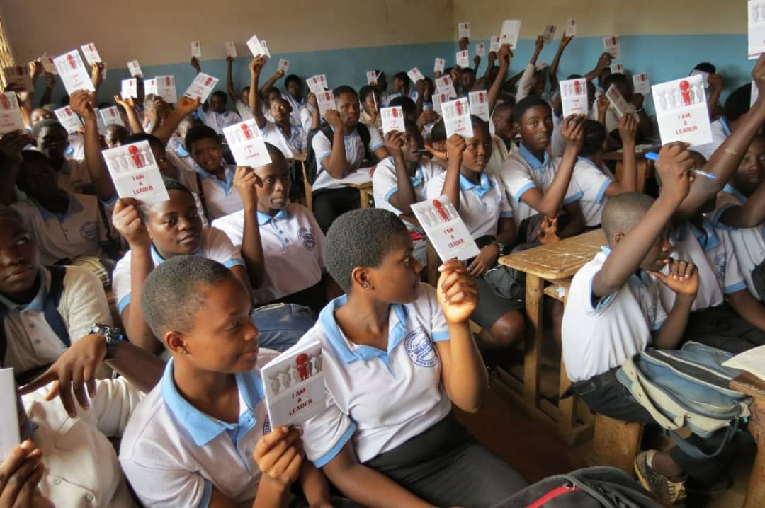 Students raising 'I Am A Leader' books